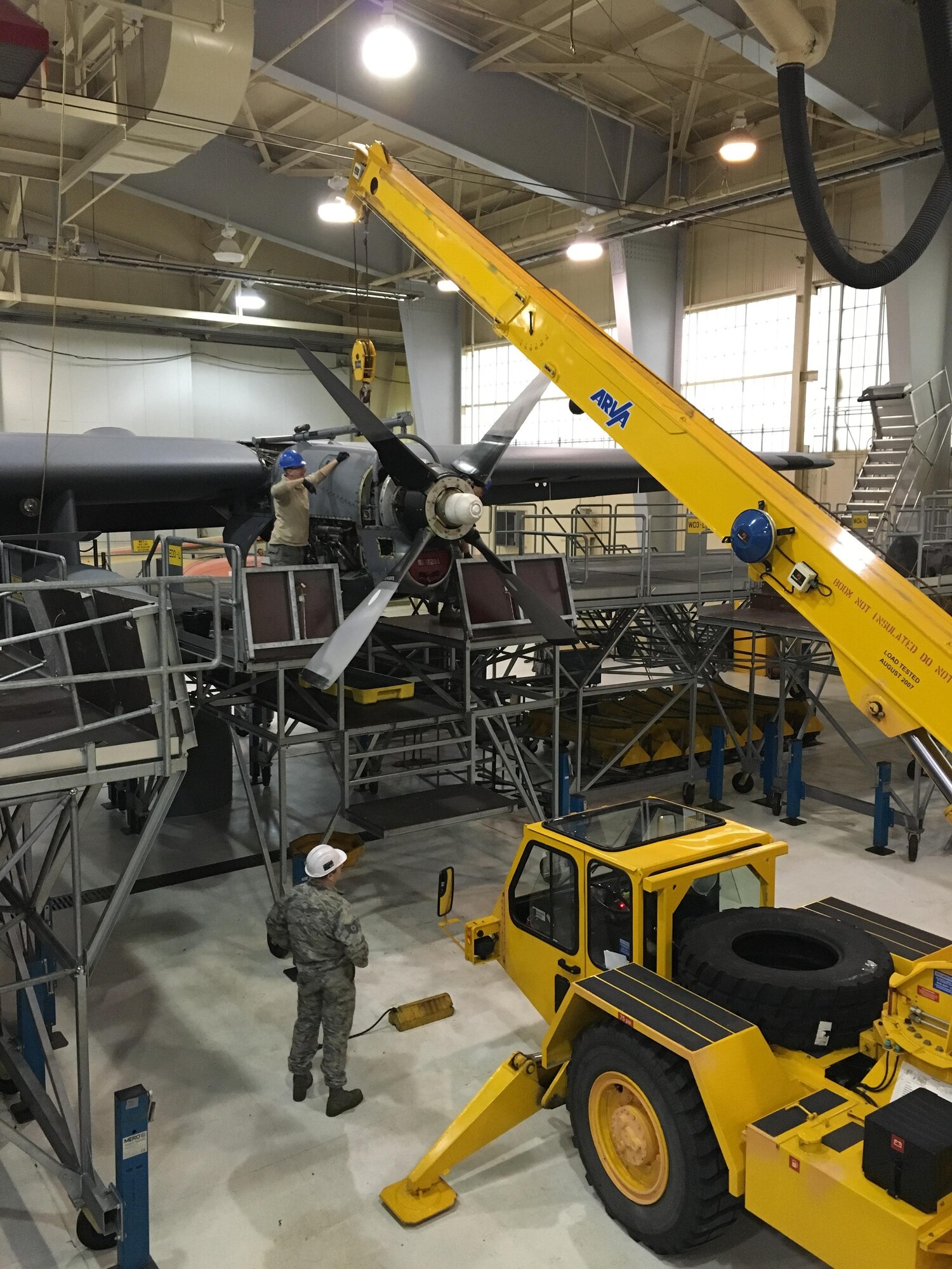 Airmen from the 914th Maintenance Group reattach a propeller to an engine of a C-130 Hercules aircraft March 3, 2016 at the Niagara Falls Air Reserve Station. The aircraft underwent a routine inspection as part of required maintenance. (U.S. Air Force photo by Staff Sgt. Richard Mekkri/released)