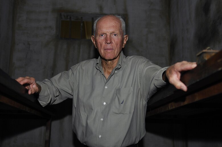 Lt. Col. (ret) Jay Hess stands in a replica of a prison cell at the Hill Aerospace Museum in Roy, UT July 2, 2010. He spent seven years in a similar cell as a prisoner of war during the Vietnam War. Hess's F-105 Thunderchief was shot down over North Vietnam August 24, 1967 where he was taken prisoner and held for 2,030 days untill released November 1, 1973. He currently lives in Farmington, Utah. (U.S. Air Force photo by Staff Sgt. Tim Chacon)
