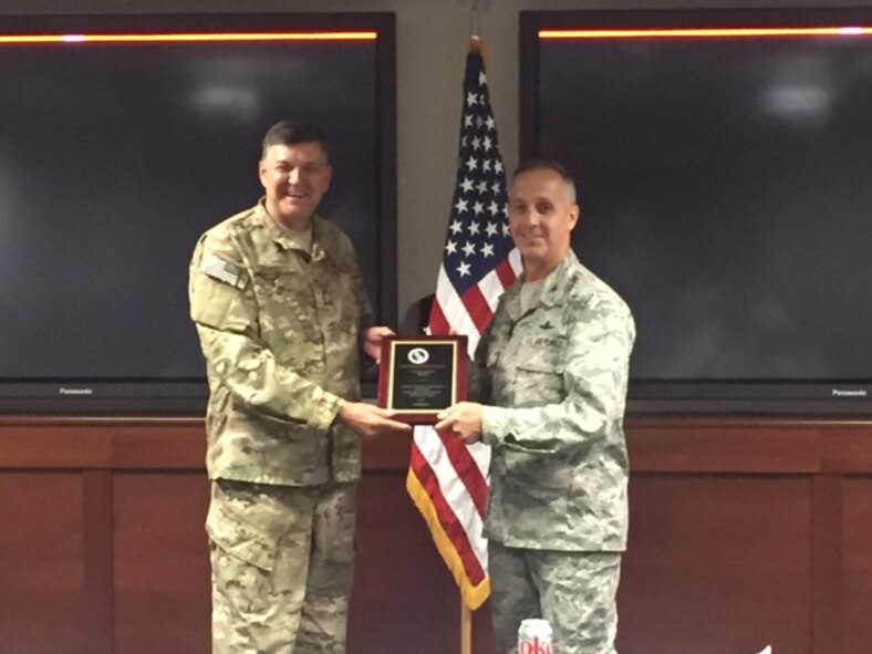 Lt. Gen. Brad Heithold, commander of Air Force Special Operations Command, presents the Cyber Safety Award to Col. Anthony Thomas, AFSOC Cyber and C4 Systems director at Hurlburt Field, Fla., May 4, 2016. (Courtesy photo)