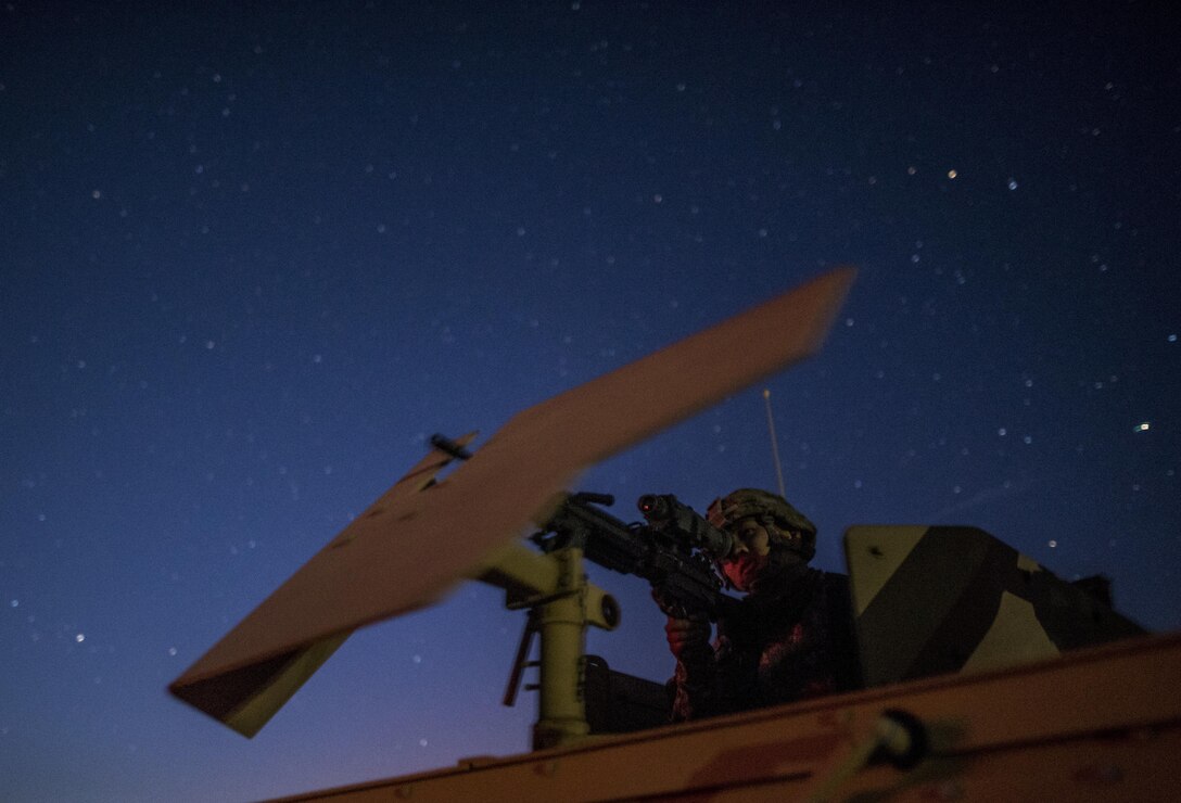 Pfc. Ryan Joe, U.S. Army Reserve military police Soldiers from the 341st MP Company, of South San Francisco, California, looks down the night vision scope of his assigned M249 Squad Automatic Weapon as he prepares for a mounted crew-served weapon night fire qualification table at Fort Hunter-Liggett, California, May 3. The 341st MP Co. is one of the first units in the Army Reserve conducting a complete 6-table crew-serve weapon qualification, which includes firing the M2, M249 and M240B machine guns both during the day and night. (U.S. Army photo by Master Sgt. Michel Sauret)