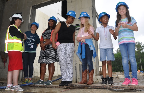 A few Diamond Elementary School students view the makings of an outdoor amphitheater at the construction site of the new school May 3. Thirteen contest winners of Archer Western Contractor’s poster contest toured the site currently under construction at Fort Stewart, Georgia. Diamond students from kindergarten through sixth-grade submitted posters emphasizing safety themes in recognition of Safety Week celebrated May 2-6. The winning submissions were printed on the firm’s calendar that will be available throughout the Fort Stewart community. 