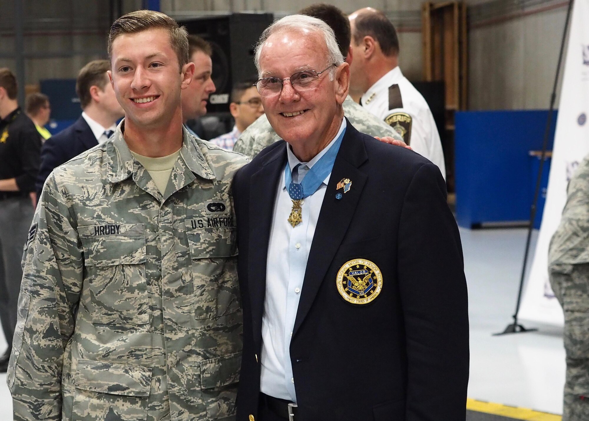 Senior Airman Justin Hruby, 27th Aerial Port Squadron, poses for a photo with Medal of Honor recipient Robert Patterson. (Air Force Photo/Paul Zadach)