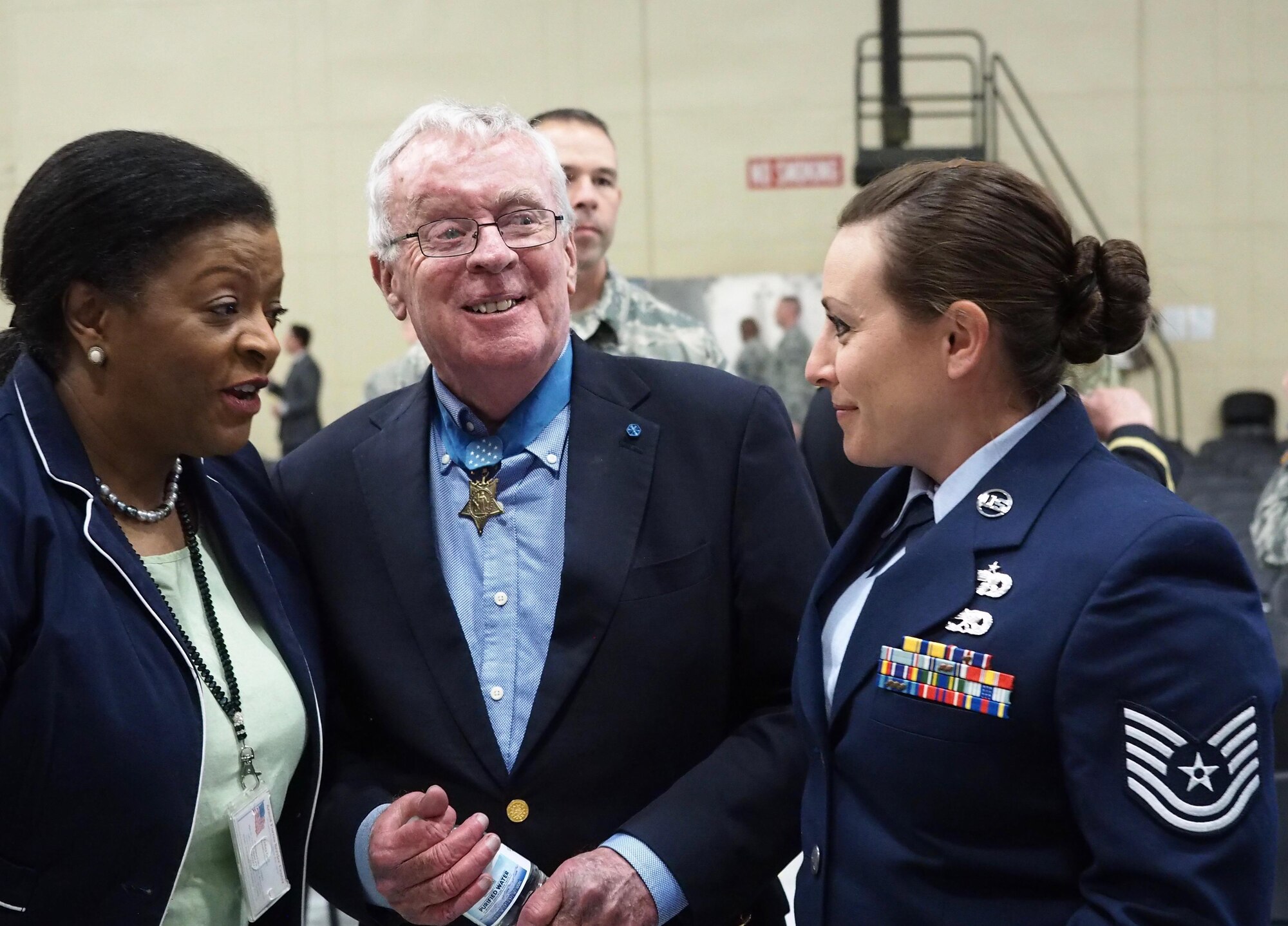 Tech. Sgt. Erica Hokkanen, 934th Development and Training Flight, talks with Medal of Honor recipient Thomas Kelley and Armed Forces Services Center Director Debra Cain. (Air Force Photo/Paul Zadach)