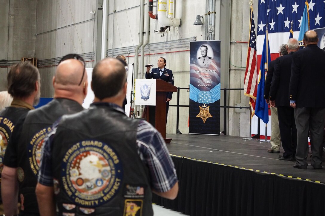 Tech. Sgt. Erica Hokkanen, 934th Development and Training Flight, sings the National Anthem before the ceremony. (Air Force Photo/Paul Zadach)