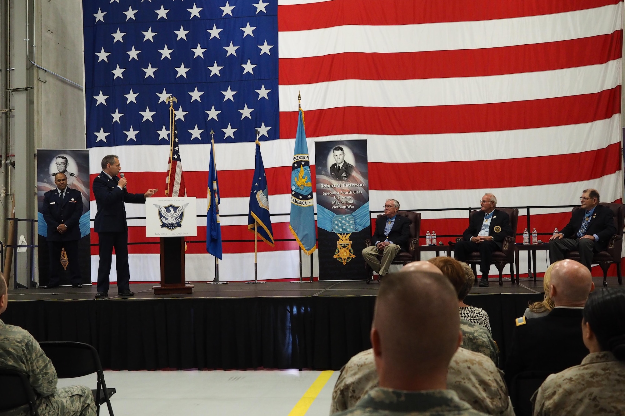Col. Anthony Polashek, 934th Airlift Wing commander, pays tribute to Medal of Honor recipients Thomas Kelley, Robert Patterson and Harold Fritz. (Air Force Photo/Paul Zadach)