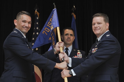 Colonel Thomas Hensley, 70th Intelligence, Surveillance and Reconnaissance Wing commander passes the group guidon to Col. David James, as he assumes command of the 691st ISR Group May 5, 2016, at Fort George G. Meade, Md. Officially in-activated September 2014 at Royal Air Force Menwith Hill Station, United Kingdom, the 691st ISRG returns and is now activated under the 70th ISR Wing. (U.S. Air Force photo/Staff Sgt. Alexandre Montes)