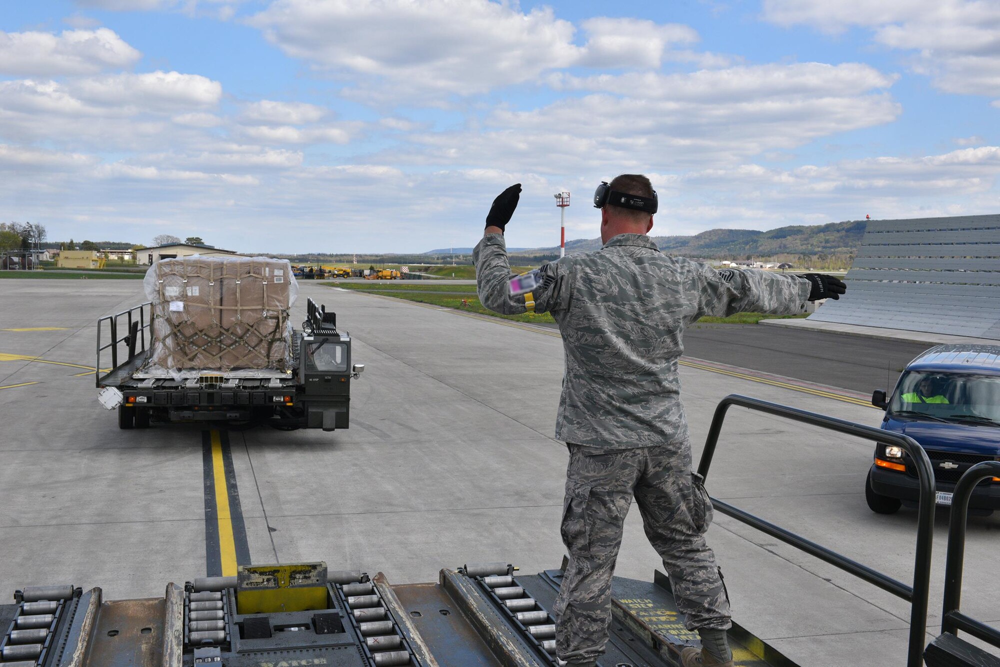 Tech. Sgt. Patrick Kirby, 87th Aerial Port Squadron, helps guide a vehicle as he works with his fellow Airmen to move pallets during their annual tour here April 19, 2016.  More than 90 Airmen from 445th Logistics Readiness Squadron, 445th Force Support Squadron, 445th Aeromedical Evacuation Squadron and the 87th Aerial Port trained alongside their active duty counterparts on routine operational procedures during their training here.  (U.S. Air Force photo/Tech. Sgt. Frank Oliver)