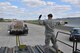 Tech. Sgt. Patrick Kirby, 87th Aerial Port Squadron, helps guide a vehicle as he works with his fellow Airmen to move pallets during their annual tour here April 19, 2016.  More than 90 Airmen from 445th Logistics Readiness Squadron, 445th Force Support Squadron, 445th Aeromedical Evacuation Squadron and the 87th Aerial Port trained alongside their active duty counterparts on routine operational procedures during their training here.  (U.S. Air Force photo/Tech. Sgt. Frank Oliver)