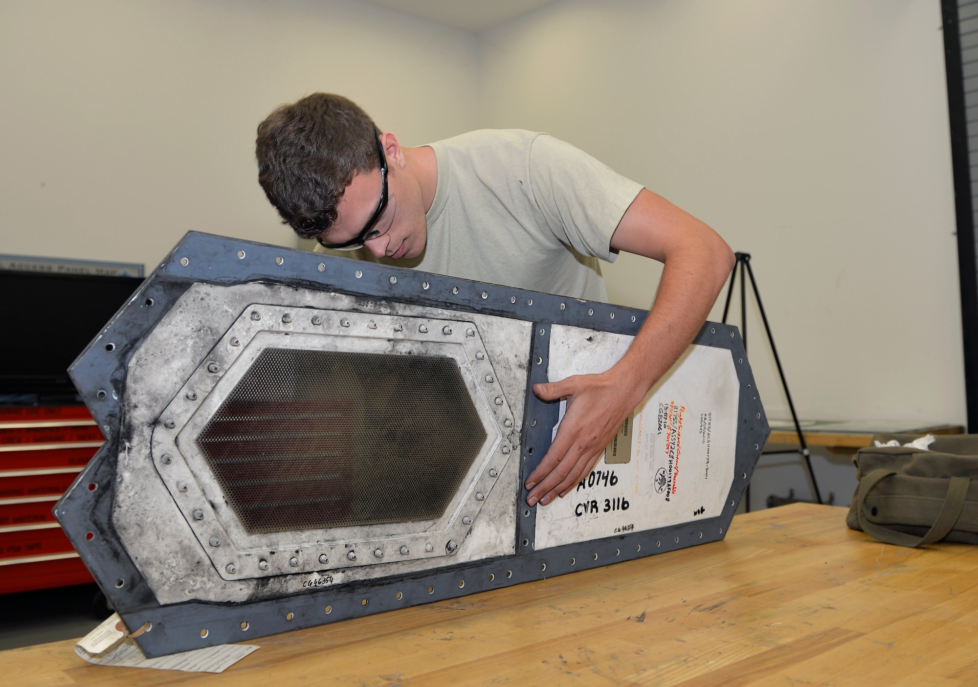 Senior Airman Tyler Quayle, 33rd Maintenance Squadron low observable maintenance journeyman, holds an F-35A Lightning II panel steady as he replaces a grommet at Eglin Air Force Base, Fla., April 28, 2016. The low observable maintenance shop conducts maintenance and inspects panels for structural damage daily. (U.S. Air Force photo/Senior Airman Andrea Posey)