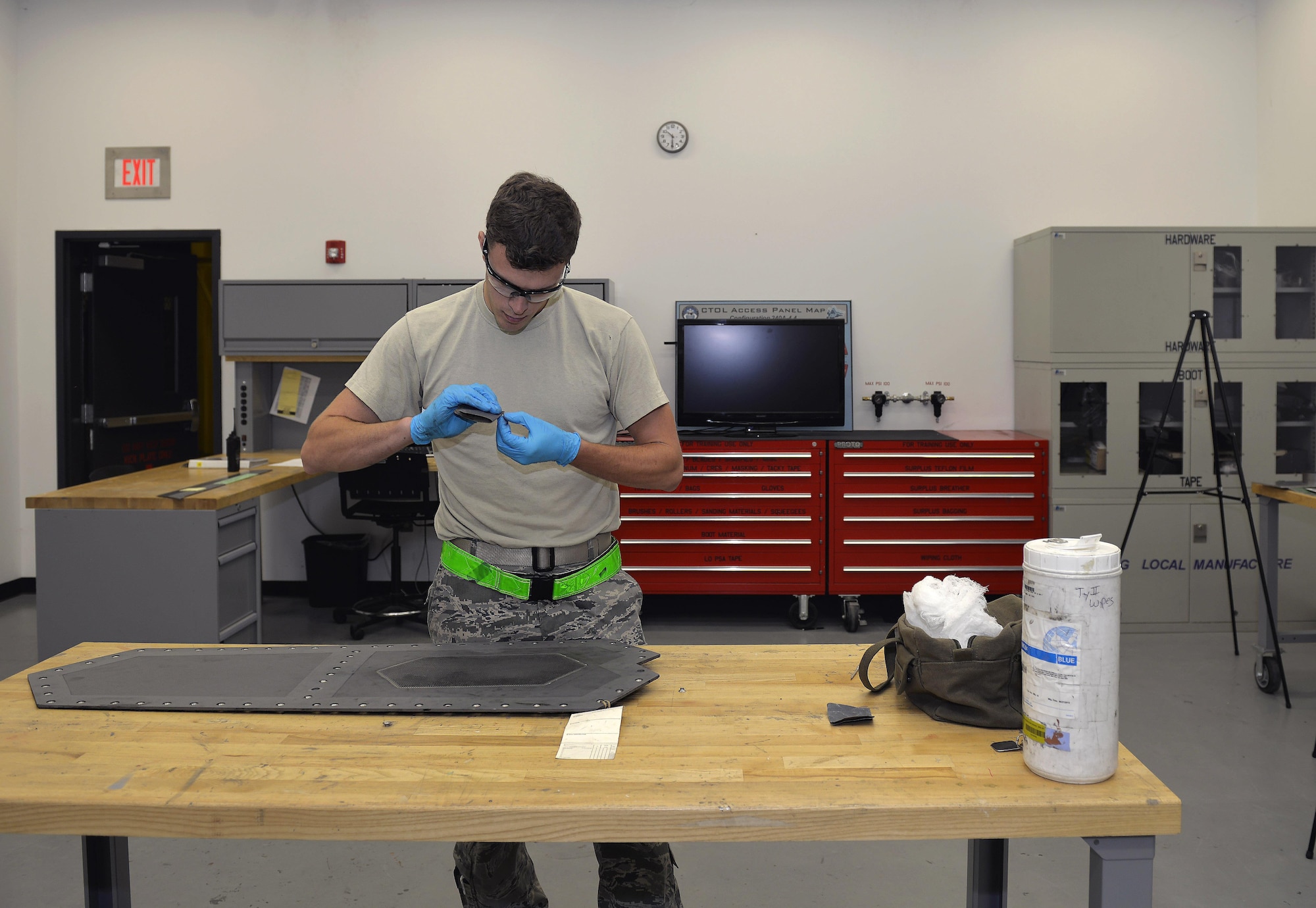 Senior Airman Tyler Quayle, 33rd Maintenance Squadron low observable maintenance journeyman, cleans a grommet from an F-35A Lightning II panel at Eglin Air Force Base, Fla., April 28, 2016. The grommet must be cleaned before placement to ensure proper bonding of adhesives used to keep parts in place. (U.S. Air Force photo/Senior Airman Andrea Posey)