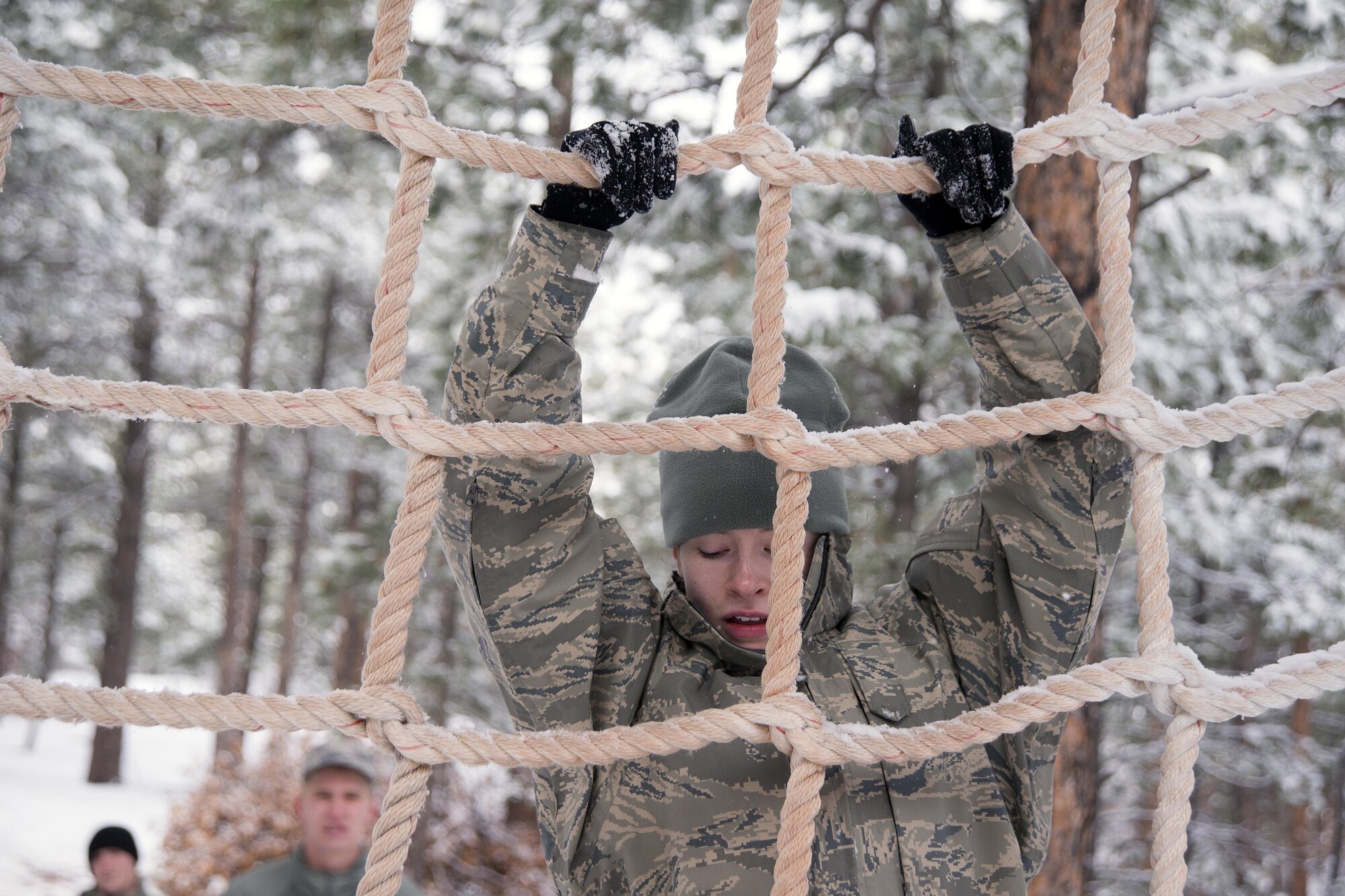 A cadet descends a rope net at the obstacle course in Jacks Valley April 30, 2016, during Polaris Warrior at the U.S. Air Force Academy. Polaris Warrior is an annual Cadet Wing competition focused on team-building and leadership skills. (U.S. Air Force photo/Bill Evans)