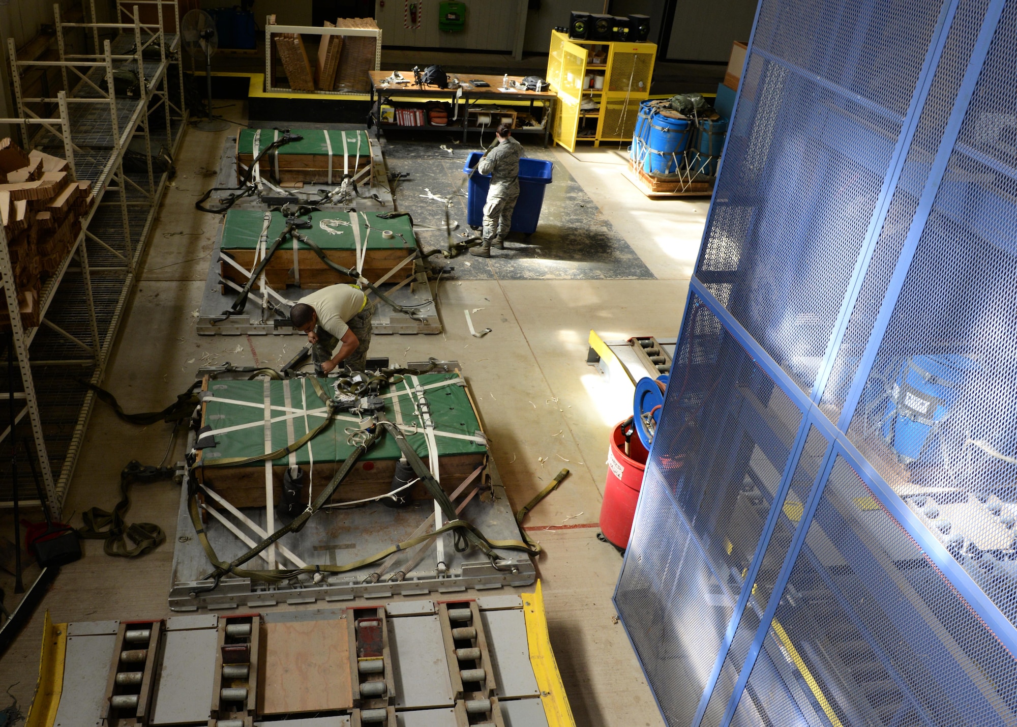 U.S. Air Force Senior Airmen Derek Bradley and U.S. Air Force Airman 1st Class Courtney Nickel, 97th Logistics Readiness Squadron aerial delivery specialists, assemble and secure platforms loaded with simulated cargo, May 2, 2016, Altus Air Force Base, Okla. Riggers build each platform used for loadmaster air drop training from the ground up, including packing the parachutes, securing the cargo, loading it into the aircraft and recovering it after it has landed. (U.S. Air Force photo by Senior Airman Nathan Clark/Released)