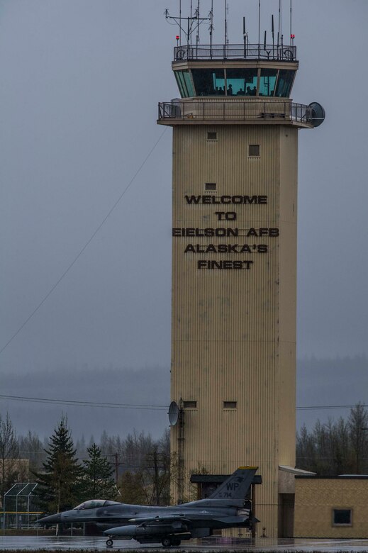 A U.S. Air Force F-16 Fighting Falcon assigned to the 80th Fighter Squadron, Kunsan Air Base, Republic of Korea, taxis in front of the air traffic control tower on Eielson Air Force Base, Alaska, May 3, 2016, during RED FLAG-Alaska (RF-A) 16-1. Eielson’s air traffic controllers monitor all aircraft in order to prevent accidents by directing the movement of aircraft into and out of the airfield. (U.S. Air Force photo by Staff Sgt. Joshua Turner/Released)