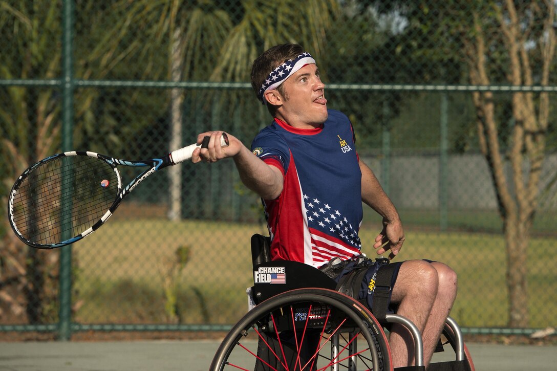 Retired Navy Seaman Austin Field and retired Air Force Lt. Col. Dan Oosterhous, not shown, compete against the British team in the tennis quarterfinals during the 2016 Invictus Games in Orlando, Fla., May 6, 2016. DoD photo by Roger Wollenberg
