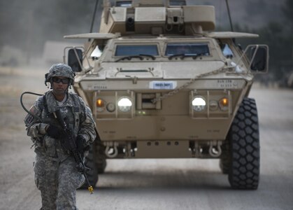 Spc. Adrianna Harris, a U.S. Army Reserve military police Soldier from Los Angeles, with the 56th Military Police Company (Combat Support), of Mesa, Arizona, ground-guides an M1117 Armored Security Vehicle in preparation for a cordon and search training lane at Fort Hunter-Liggett, California, May 4. Approximately 80 units from across the U.S. Army Reserve, Army National Guard and active Army are participating in the 84th Training Command's second Warrior Exercise this year, WAREX 91-16-02, hosted by the 91st Training Division at Fort Hunter-Liggett, California. (U.S. Army photo by Master Sgt. Michel Sauret)