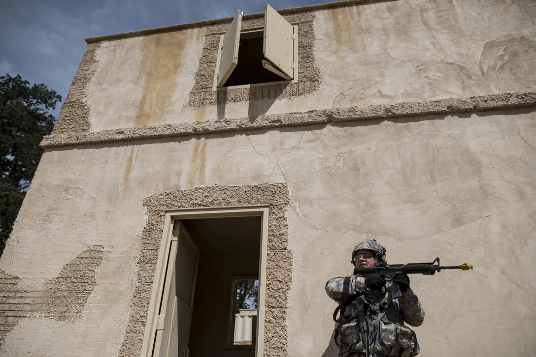 A U.S. Army Reserve military police Soldier from the 56th Military Police Company (Combat Support), of Mesa, Arizona, pulls security outside of a building during a cordon and search training lane at Fort Hunter-Liggett, California, May 4. Approximately 80 units from across the U.S. Army Reserve, Army National Guard and active Army are participating in the 84th Training Command's second Warrior Exercise this year, WAREX 91-16-02, hosted by the 91st Training Division at Fort Hunter-Liggett, California. (U.S. Army photo by Master Sgt. Michel Sauret)
