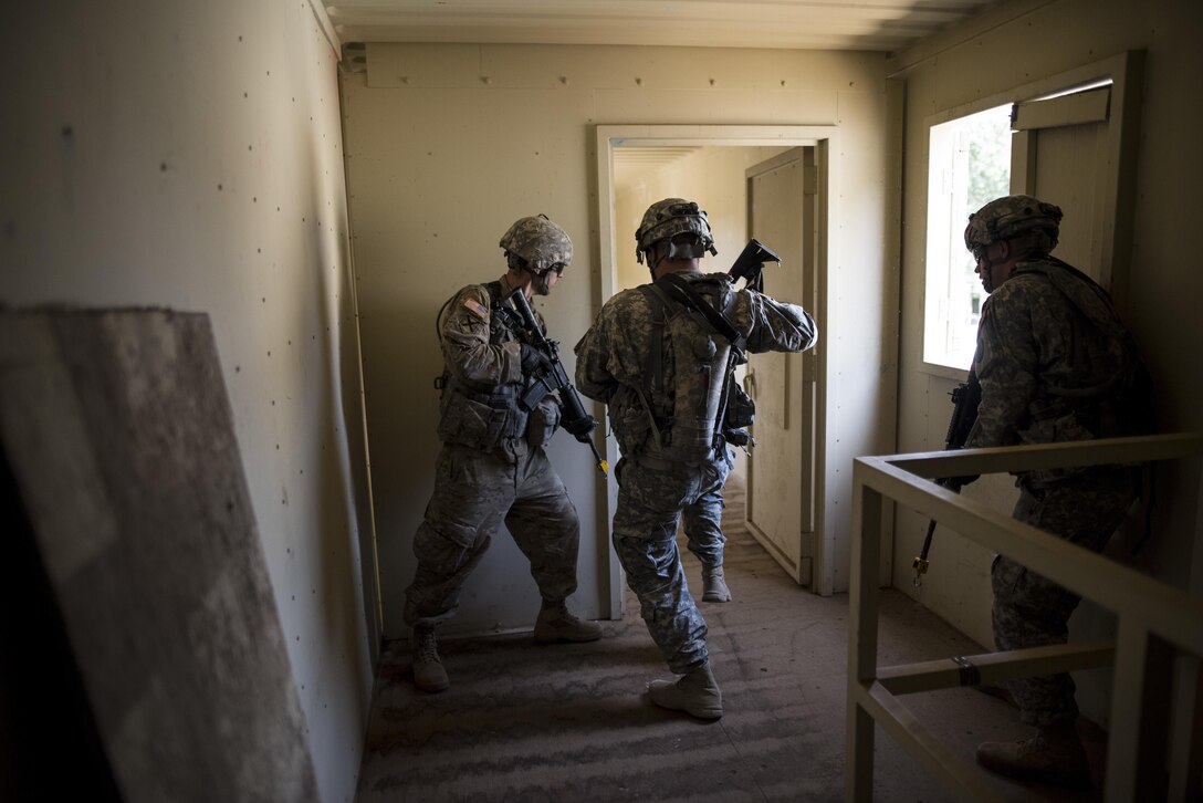 A team of U.S. Army Reserve military police Soldiers from the 56th Military Police Company (Combat Support), of Mesa, Arizona, clear a building in a makeshift village during a cordon and search training lane at Fort Hunter-Liggett, California, May 4. Approximately 80 units from across the U.S. Army Reserve, Army National Guard and active Army are participating in the 84th Training Command's second Warrior Exercise this year, WAREX 91-16-02, hosted by the 91st Training Division at Fort Hunter-Liggett, California. (U.S. Army photo by Master Sgt. Michel Sauret)