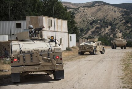 A convoy of gunner vehicles pull security in a makeshift village during a cordon and search training lane at Fort Hunter-Liggett, California, conducted by U.S. Army Reserve military police Soldiers from the 56th Military Police Company (Combat Support), of Mesa, Arizona, May 4. Approximately 80 units from across the U.S. Army Reserve, Army National Guard and active Army are participating in the 84th Training Command's second Warrior Exercise this year, WAREX 91-16-02, hosted by the 91st Training Division at Fort Hunter-Liggett, California. (U.S. Army photo by Master Sgt. Michel Sauret)