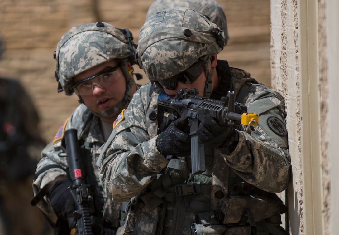 A team of U.S. Army Reserve military police Soldiers from the 56th Military Police Company (Combat Support), of Mesa, Arizona, prepare to clear a building in a makeshift village during a cordon and search training lane at Fort Hunter-Liggett, California, May 4. Approximately 80 units from across the U.S. Army Reserve, Army National Guard and active Army are participating in the 84th Training Command's second Warrior Exercise this year, WAREX 91-16-02, hosted by the 91st Training Division at Fort Hunter-Liggett, California. (U.S. Army photo by Master Sgt. Michel Sauret)