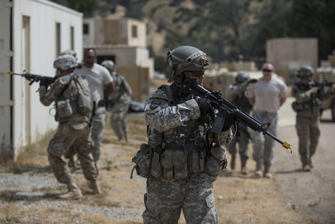 Two teams of U.S. Army Reserve military police Soldiers from the 56th Military Police Company (Combat Support), of Mesa, Arizona, find and detain two high-value targets during a cordon and search training lane at Fort Hunter-Liggett, California, May 4. Approximately 80 units from across the U.S. Army Reserve, Army National Guard and active Army are participating in the 84th Training Command's second Warrior Exercise this year, WAREX 91-16-02, hosted by the 91st Training Division at Fort Hunter-Liggett, California. (U.S. Army photo by Master Sgt. Michel Sauret)