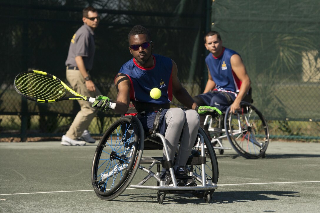 Retired Sgt. R.J. Anderson, foreground, and retired Navy Javier Rodriguez compete against the Australian team in the tennis quarterfinals during the 2016 Invictus Games in Orlando, Fla., May 6, 2016. Anderson and Rodriguez won in 6 sets and advanced to the semifinals to be held May 11. DoD photo by Roger Wollenberg