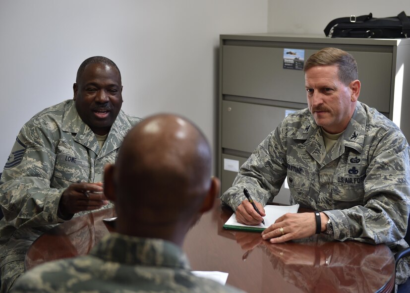 Col. Kenneth Herstine, 910th inspector general (IG), and Master Sgt. Princeton Lowe, 910th IG superintendent, discuss the Air Force complaint resolution process with a member, here, April 3, 2016. The IG complaint resolution process indicates where command involvement is needed to correct systematic, programmatic or procedural weaknesses. (U.S. Air Force photo/Staff Sgt. Rachel Kocin)