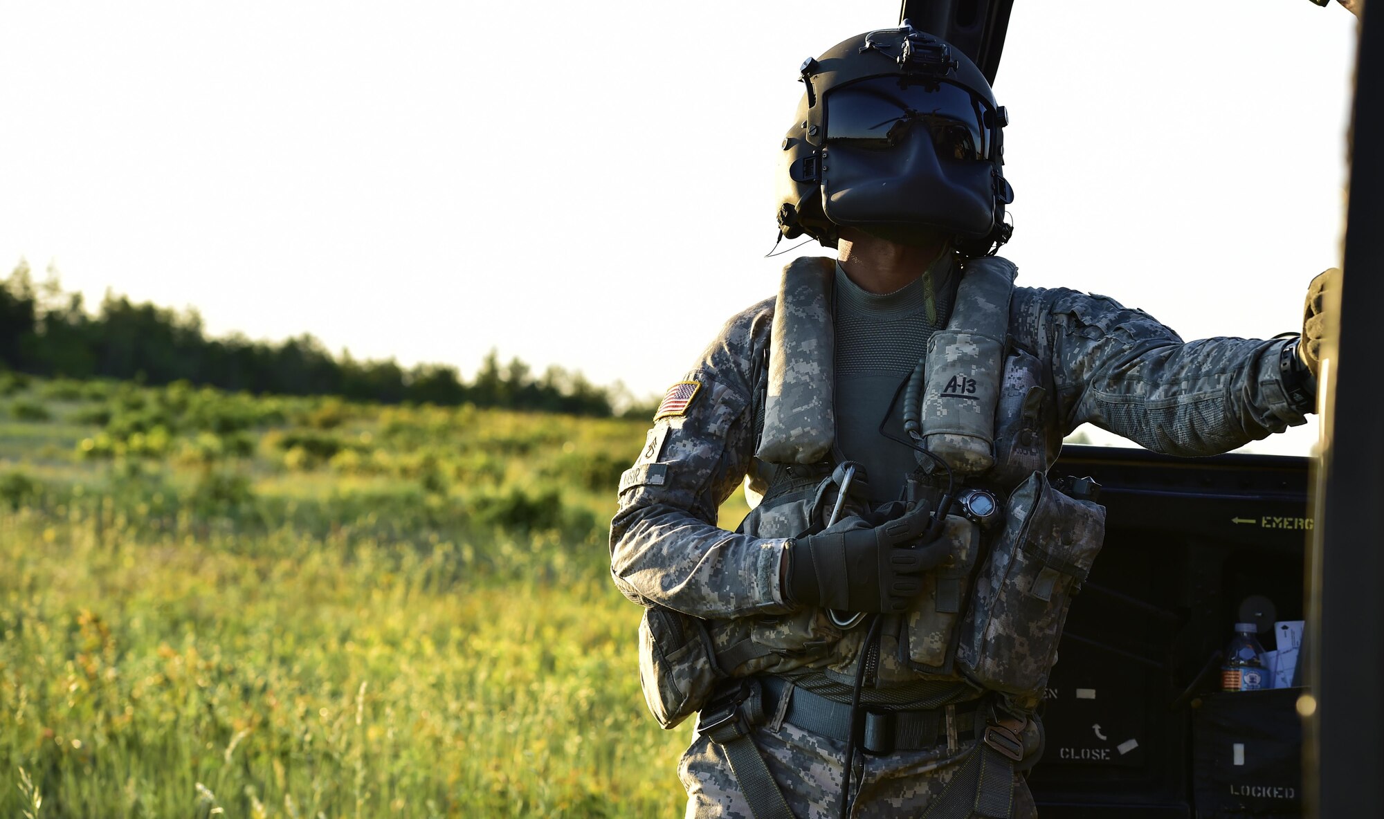A U.S. Army crew chief from the 11th Aviation Brigade takes a break outside a UH-60 Black Hawk at Hurlburt Field, Fla., May 5, 2016, during Emerald Warrior. (U.S. Air Force photo by Staff Sgt. Paul Labbe)
