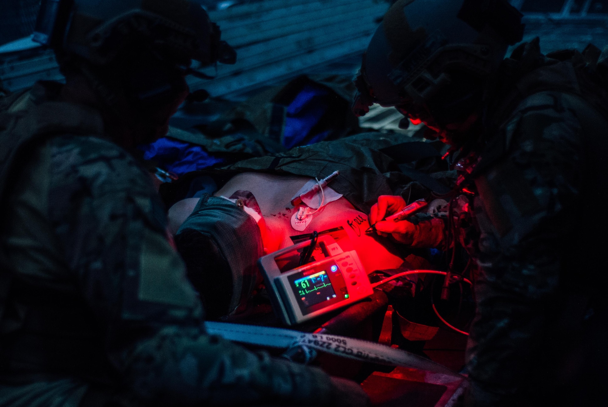 Two medics with the 1st Special Operations Support Squadron tend to a simulated injured Airman during Emerald Warrior at Hurlburt Field, Fla., May 5, 2016. Emerald Warrior is a U.S. Special Operations Command sponsored mission rehearsal exercise during which joint special operations forces train to respond to real and emerging worldwide threats. (U.S. Air Force photo by Senior Airman Jordan Castelan)