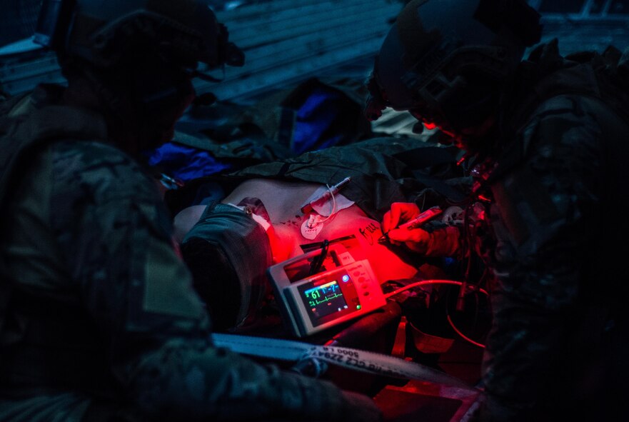 Two medics with the 1st Special Operations Support Squadron tend to a simulated injured Airman during Emerald Warrior at Hurlburt Field, Fla., May 5, 2016. Emerald Warrior is a U.S. Special Operations Command sponsored mission rehearsal exercise during which joint special operations forces train to respond to real and emerging worldwide threats. (U.S. Air Force photo by Senior Airman Jordan Castelan)