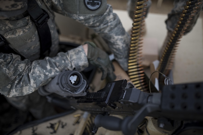 U.S. Army Reserve military police Soldiers from the 341st MP Company, of Mountain View, California, prepare an M249 Squad Automatic Weapon for a mounted crew-served weapon night fire qualification table at Fort Hunter-Liggett, California, May 4. The 341st MP Co. is one of the first units in the Army Reserve conducting a complete 6-table crew-serve weapon qualification, which includes firing the M2, M249 and M240B machine guns both during the day and night. (U.S. Army photo by Master Sgt. Michel Sauret)