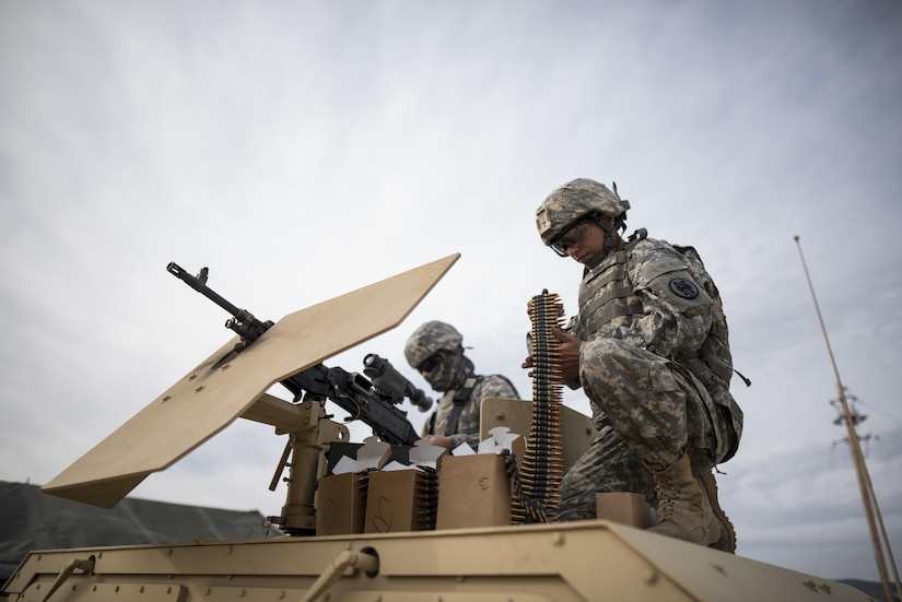 U.S. Army Reserve military police Soldiers from the 341st MP Company, of Mountain View, California, prepare an M240B machine gun for a mounted crew-served weapon night fire qualification table at Fort Hunter-Liggett, California, May 4. The 341st MP Co. is one of the first units in the Army Reserve conducting a complete 6-table crew-serve weapon qualification, which includes firing the M2, M249 and M240B machine guns both during the day and night. (U.S. Army photo by Master Sgt. Michel Sauret)