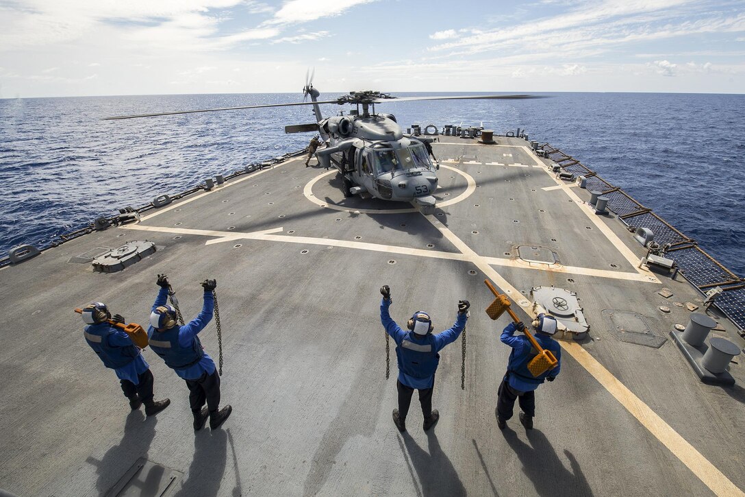 Sailors show chocks and chains to an MH-60S Sea Hawk helicopter on the flight deck of the USS Gonzalez in the Gulf of Aden, April 28, 2016. The Gonzalez is supporting maritime security operations and theater security cooperation efforts in the U.S. 5th Fleet area of operations. Navy photo by Petty Officer 3rd Class Pasquale Sena