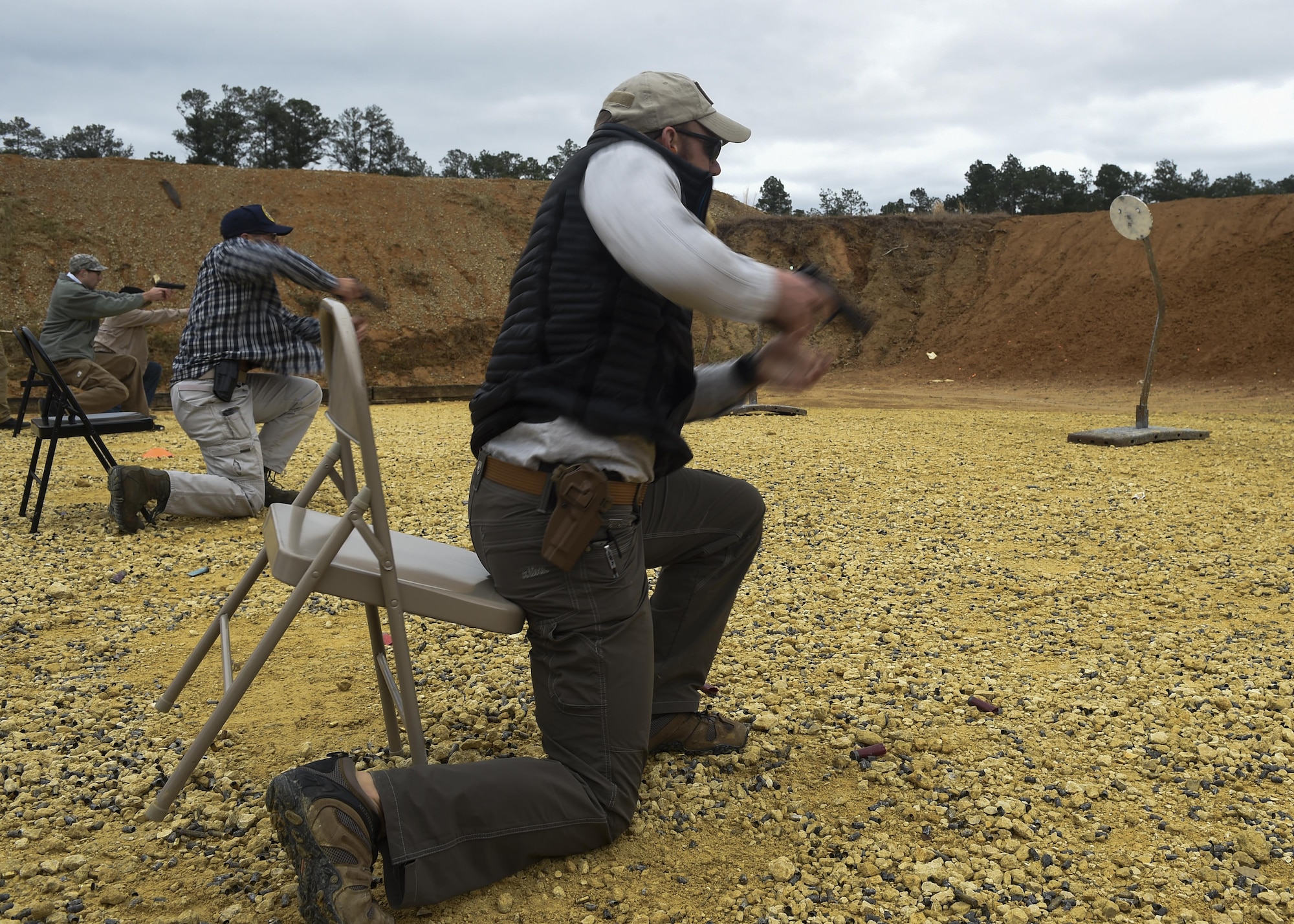 Air Force Special Operations Command Air Commandos practice drawing and firing their concealed M9 pistols from a seated position at a firing range near Baker, Fla., Feb. 24, 2016. Air Commandos practiced concealed carry techniques, such as speed drills and firing from inconvenient positions, along with other advanced firearms training during three days of rifle and pistol training during an Air Commando Field Skills Course. During the second stage of pistol training, Airmen learned conceal carry as well as moving and shooting techniques. (U.S. Air Force photo by Airman 1st Class Kai White) 