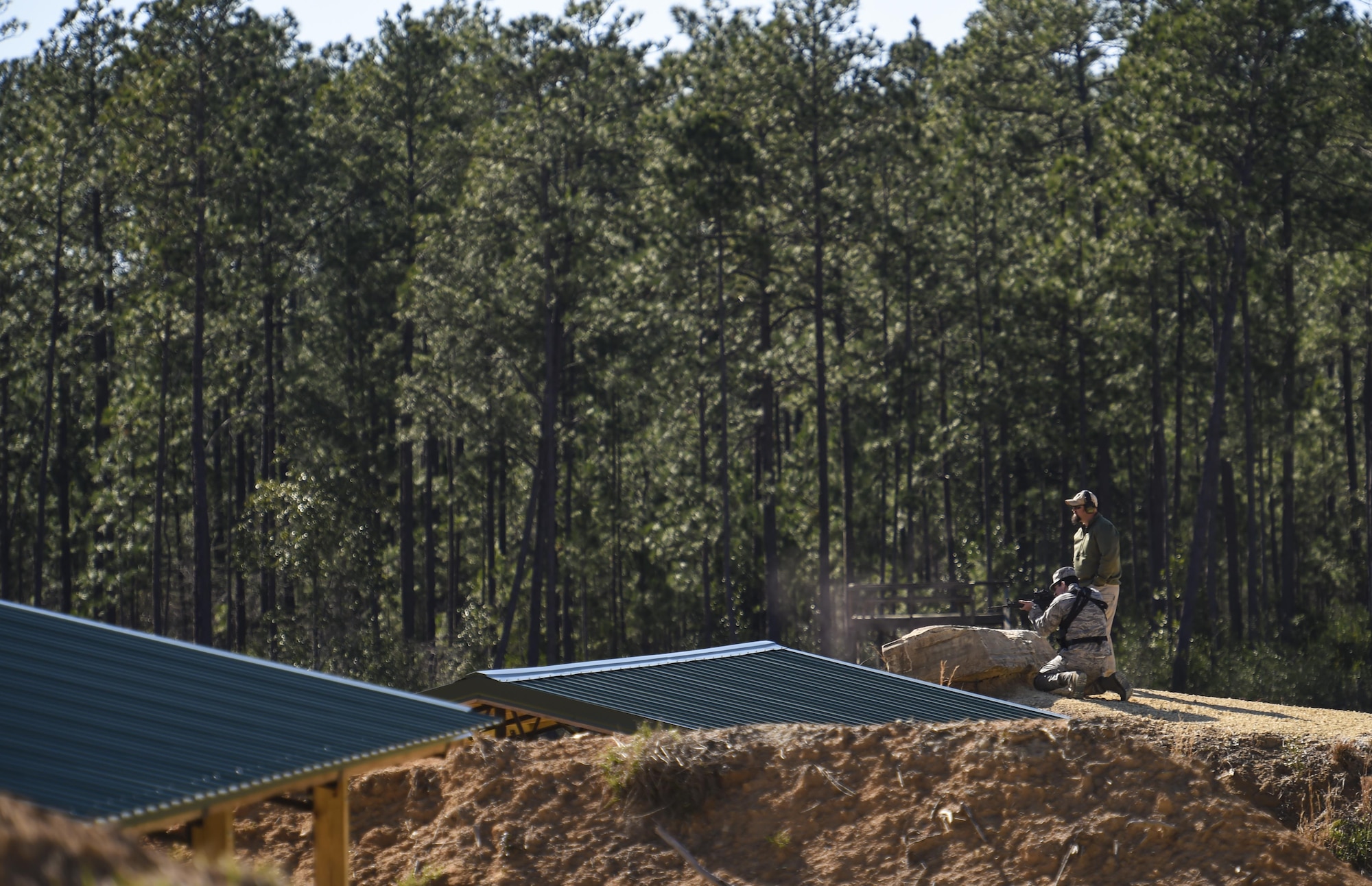 A field skills instructor with the 371st Special Operations Combat Training Squadron directs Capt. Travis Chase, a combat systems officer with the 19th Special Operations Squadron, to engage steel targets downrange during the ‘stress test’ at a firing range near Baker, Fla., Feb. 25, 2016. At the end of three days of rifle and pistol training, Air Commandos ran through a ‘stress test,’ giving them a chance to put their training to use while under taxing mental and physical conditions similar to those demanded on the battlefield. (U.S. Air Force photo by Airman 1st Class Kai White)