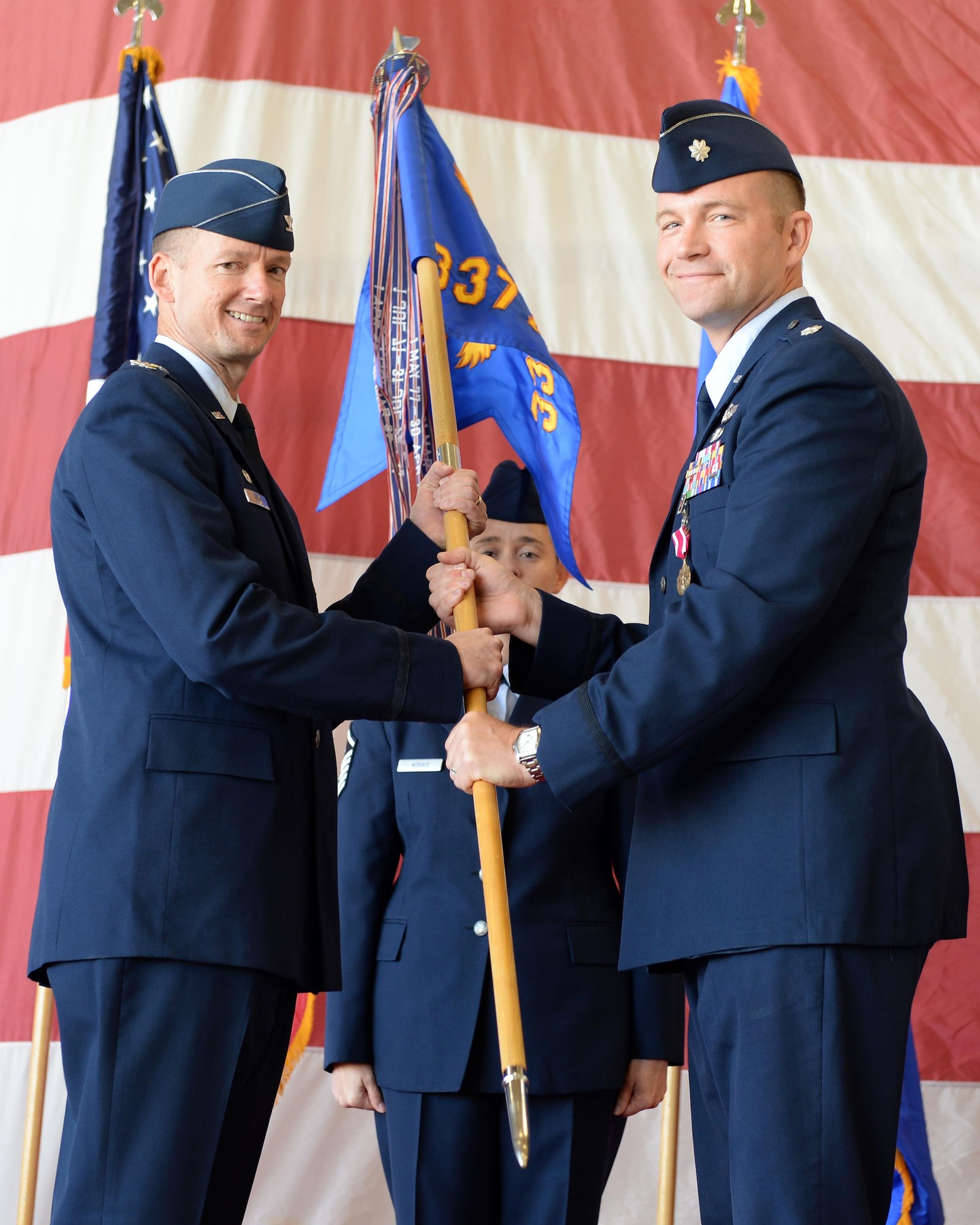 Col. Christopher Niemi, 33rd Fighter Wing Operations Group commander, passes the guidon to Lt. Col. Keith McGuire, incoming 337th Air Control Squadron commander, during a change of command at Tyndall Air Force Base, Fla., May 5, 2016. The 337th ACS is assigned to the 33rd Fighter Wing at Eglin AFB, Fla. The squadron's primary responsibilities include training all U.S. Air Force, Air National Guard and Air Force Reserve air battle manager officers for command and control missions on a variety of weapons systems in support of air expeditionary forces worldwide. (U.S. Air Force photo/Airman 1st Class Cody R. Miller)