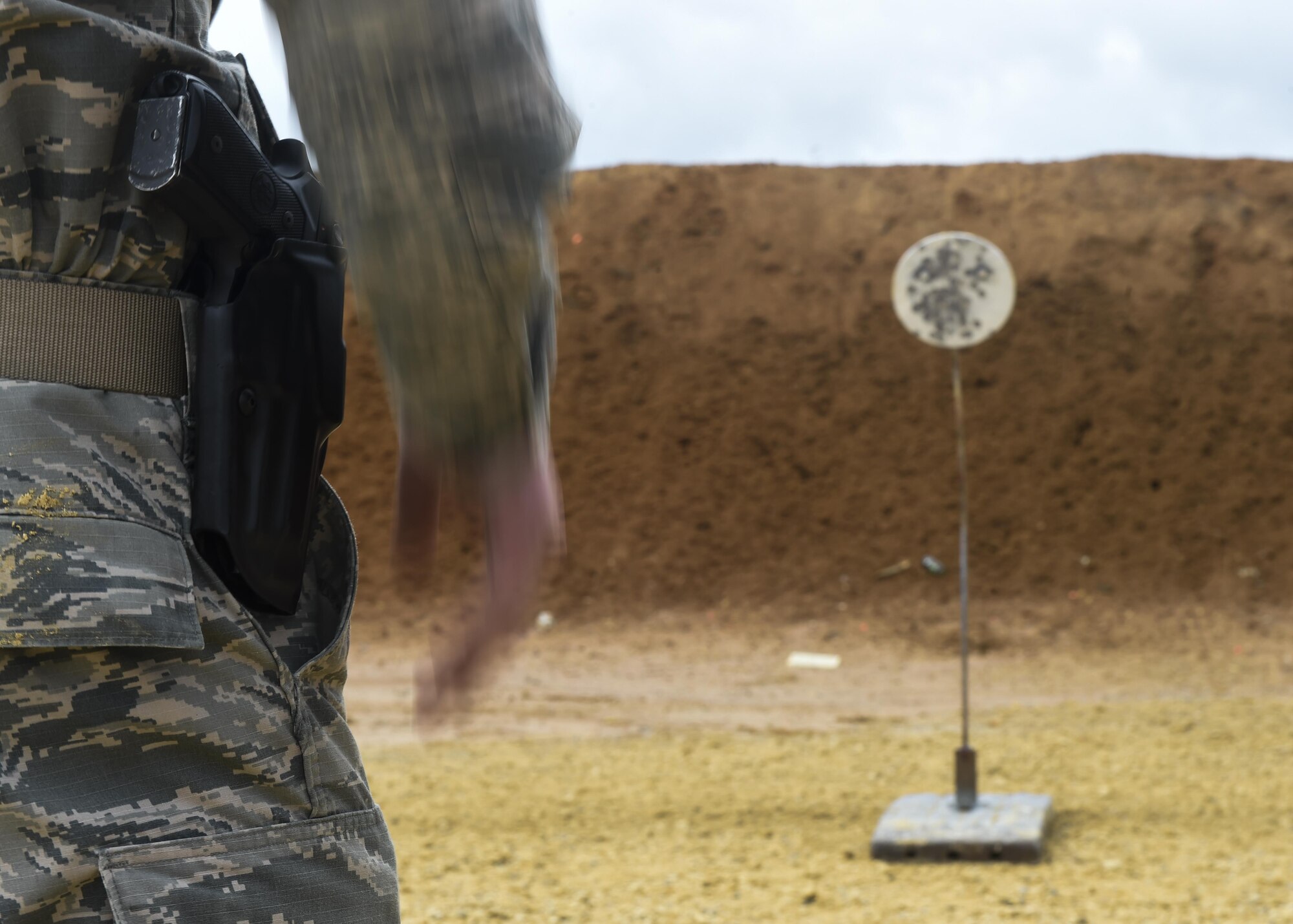Airman 1st Class Logan Fuchs, a tactical systems operator with the 19th Special Operations Squadron, practices drawing and firing his M9 pistol at a firing range near Baker, Fla., Feb. 23, 2016. Students attempted to draw and fire five shots at a target in less than three-and- a-half seconds, the approximate time it takes someone to get close enough to attack with an edged weapon. In the first stage of training, Airmen learn the basics of firearms manipulation and employment before continuing to more advanced training. (U.S. Air Force photo by Airman 1st Class Kai White)
