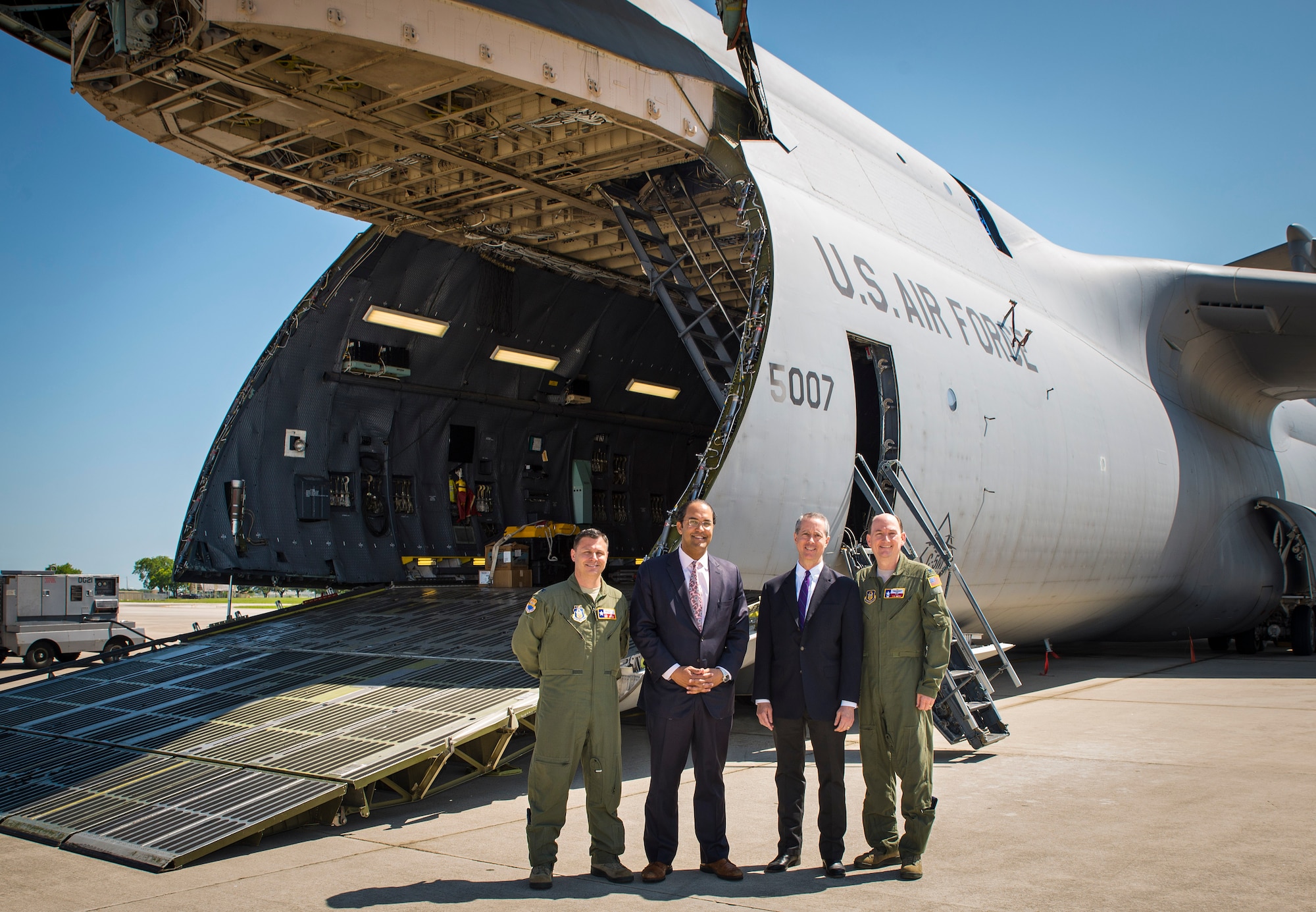 From left: Col. Lee Merkle, 433rd Operations Group commander, U.S. Rep. William Hurd, 23rd District of Texas, U.S. Rep. Mac Thornberry, 13th District of Texas, and Col. Thomas Smith, 433rd Airlift Wing commander, pose in front of a C-5M Super Galaxy aircraft May 3, 2016 at Joint Base San Antonio-Lackland, Texas. The congressmen recieved a mission brief and toured a C-5 during their visit to the base. (U.S. Air Force photo by Benjamin Faske) (released)