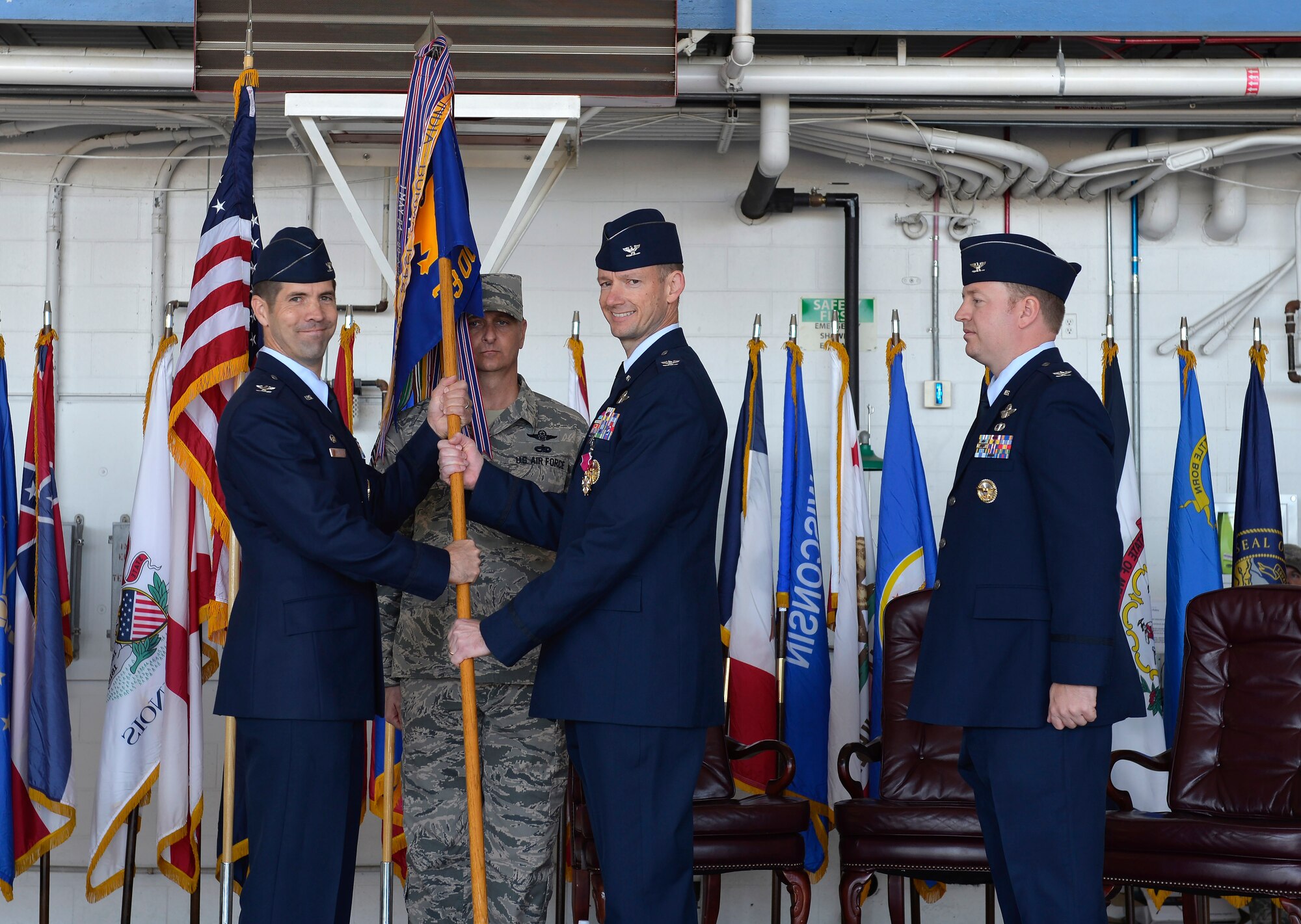 Col. Christopher Niemi, outgoing 33rd Operations Group commander, passes the guidon to Col. Lance Pilch, 33rd Fighter Wing commander, during a change of command at Eglin Air Force Base, Fla., May 5, 2016. Niemi's next perminet duty station will be at Joint Base Elmendorf-Richardson, Ala., where he will assume command of the 3rd Wing.  (U.S. Air Force Photo/Senior Airman Andrea Posey)