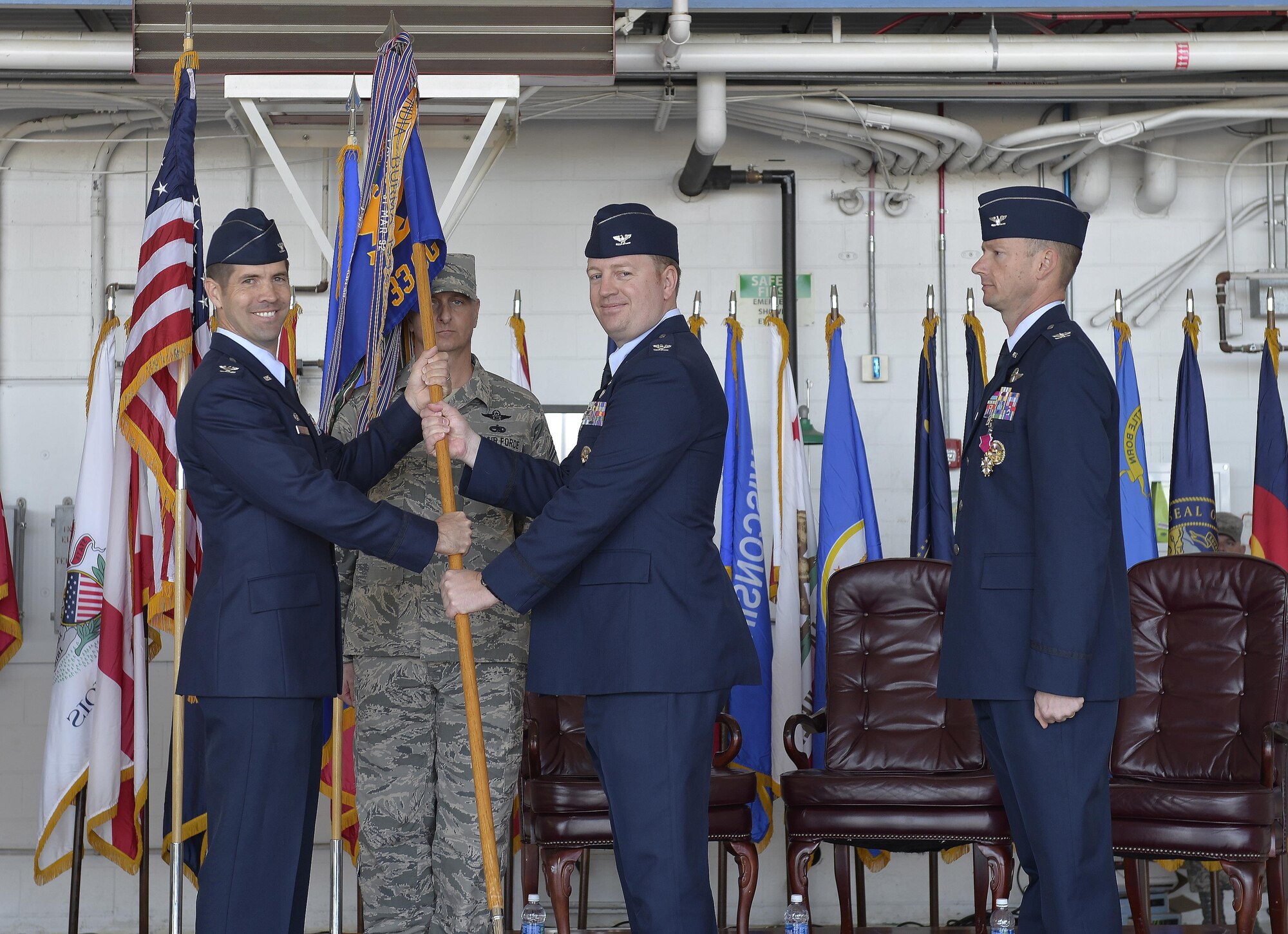 Col. Ryan Suttlemyre takes the guidon from Col. Lance Pilch, 33rd Fighter Wing commander, to assume command of the 33rd Operations Group at Eglin Air Force Base, Fla., May 5, 2016. The new commander transferred to the 33rd FW from the Pentagon in Washington D.C. where he was the assistant to the Assistant Secretary of Defense for International Security Affairs. (U.S. Air Force Photo/Senior Airman Andrea Posey)