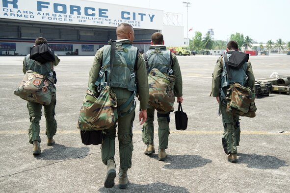 U.S. Air Force A-10C Thunderbolt II pilots walk back to the hangar at Clark Air Base, Philippines, after completing the final maritime domain awareness mission as part of U.S. Pacific Command’s first Air Contingent April 28, 2016. The pilots are deployed along with five A-10Cs, three HH-60G Pave Hawks and 200 Airmen to promote interoperability with Philippine counterparts and provide credible combat forces to the Indo-Asia-Pacific capable of a variety of missions including force projection, air and maritime domain awareness, personnel recovery, combating piracy, and assuring access to the air and maritime domains in accordance with international law. In addition to the AMDA missions over the past two weeks, the pilots flew an additional 24 sorties amounting to 59 hours of training. (U.S. Air Force photo by Capt. Susan Harrington)