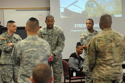 Soldiers assigned to the 85th Support Command participate in a stress management briefing exercise, April 3, 2016. The participants were thrown a ball and asked to say something that stressed them out and then toss the ball to someone new. During this exercise more balls were added into the circle and they were asked to move the balls faster each time. The soldiers developed a plan to reorganize and hand the ball to someone next to them to alleviate some of the stress of the chaos that developed after several rounds. 
(Photo by Spc. David Lietz)