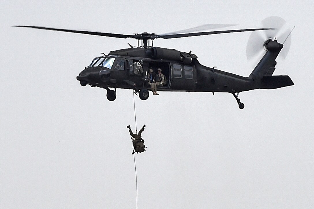 Soldiers fast-rope from a UH-60 Black Hawk during Emerald Warrior 16 at Hurlburt Field, Fla., May 3, 2016. U.S. Special Operation Command sponsors the exercise in which joint special operations forces train to respond to real and emerging worldwide threats. Air Force photo/Senior Airman Logan Carlson