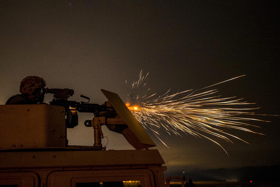 An Army Reserve soldier fires an M249 automatic weapon mounted on a high-mobility vehicle turret during a night-fire qualification at Fort Hunter Liggett, Calif., May 4. The soldier is assigned to the 341st Military Police Company. Army photo by Master Sgt. Michel Sauret