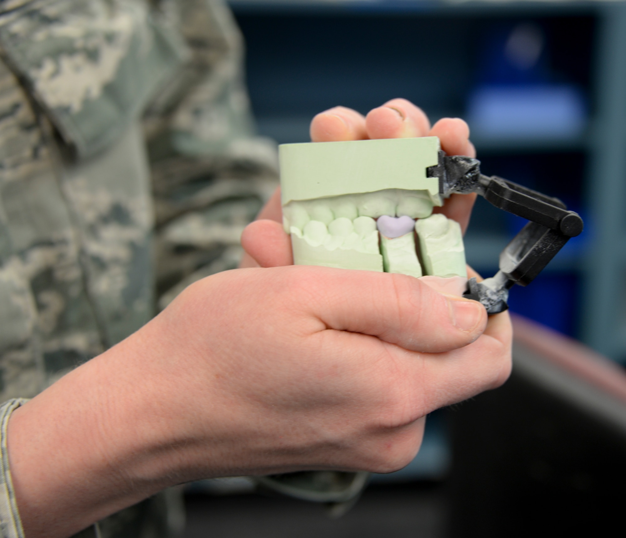 Airman 1st Class Jessica Strole, 60th DS dental lab technician, holds a molding showing a recently made crown May 2 at Travis Air Force Base, Calif. The newly-made crown is fitted to a previously-made mold of the patients mouth to make sure it will fit.. (U.S. Air Force photo by Senior Airman Amber Carter)