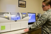 Airman 1st Class Jessica Strole, 60th DS dental lab technician, monitors a cerec cad/cam machine May 2 at Travis Air Force Base, Calif. Once it is determined that a crown is needed, a digital image of the tooth is used to tell the cerec cad/cam what dimensions are needed to make it. (U.S. Air Force photo by Senior Airman Amber Carter)