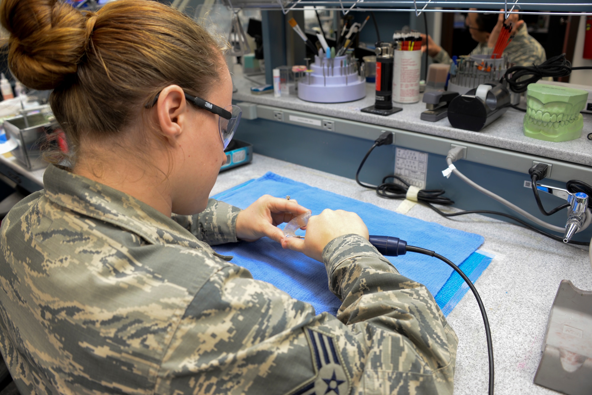 Senior Airman Mackenzie Vitale, 60th DS dental lab technician, performs a surgical guide for implants May 2 at Travis Air Force Base, California. If molds or crowns are needed, dental lab technicians perform a variety of molding work for dental appliances. (U.S. Air Force photo by Senior Airman Amber Carter)