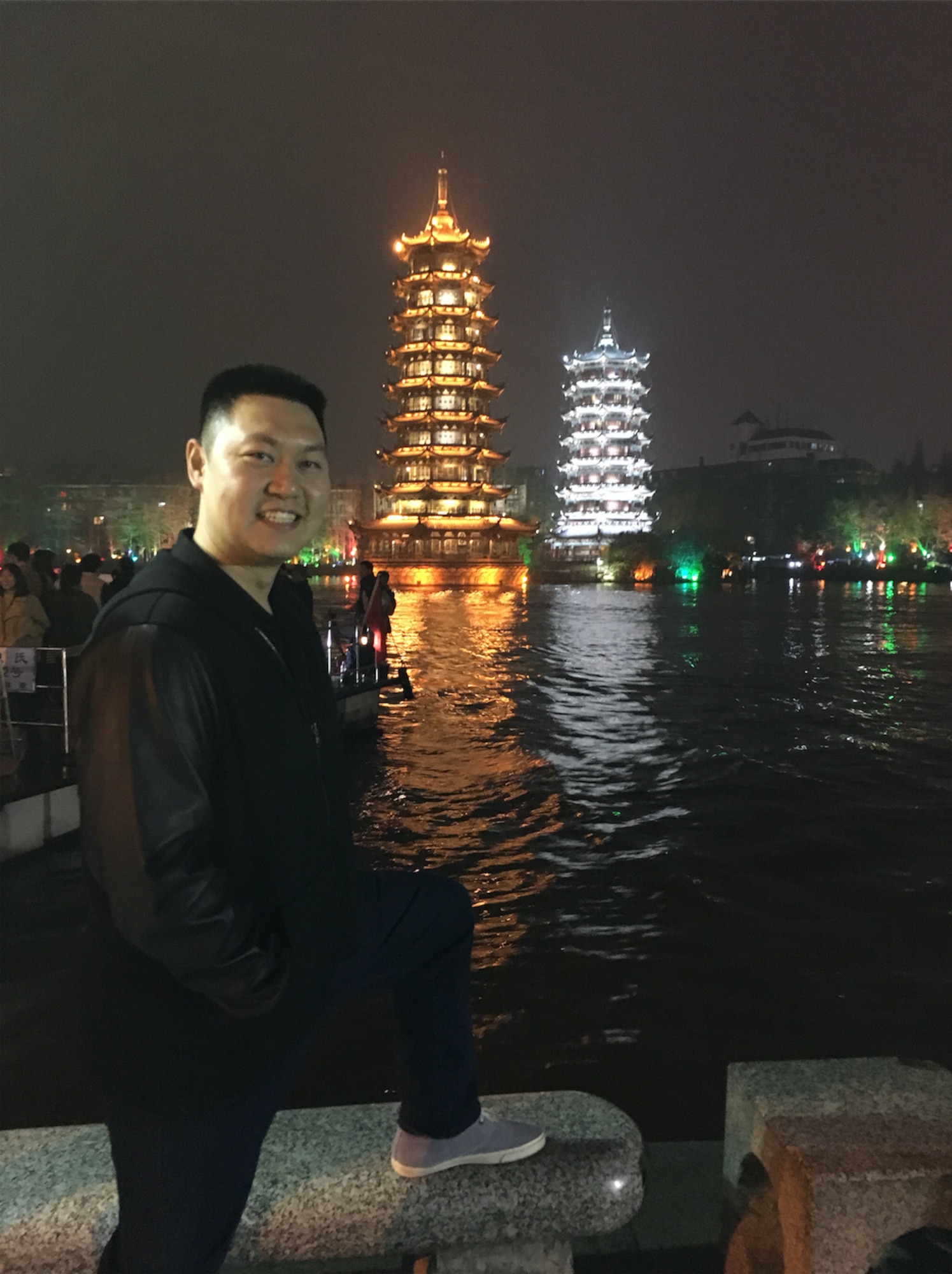 Capt. Raymond Zhang, 22nd Airlift Squadron pilot, poses for a photo in Guilin, China, with illuminated pagodas in the background. Zhang went to China in March to serve as a translator as part of an Air War College visit to the Asian nation. (Courtesy photo)