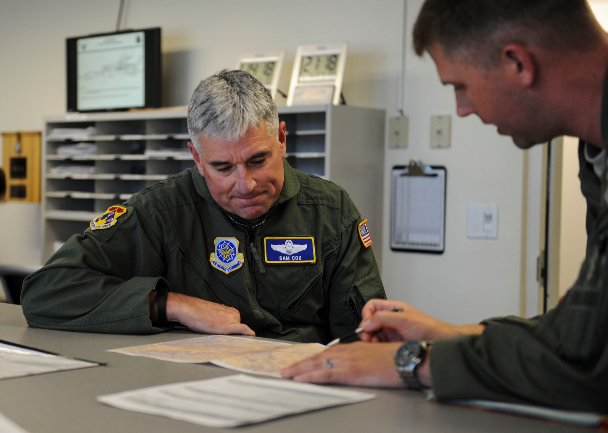 Lt. Gen. Sam Cox, 18th Air Force commander, participates in a mission brief with Capt. Tim McBride, 92nd Operations Squadron Block 45 Training program manager May 4, 2016, at Fairchild Air Force Base, Wash. During the mission brief they discussed routing and procedures for their KC-135 Stratotanker flight. (U.S. Air Force photo/ Airman 1st Class Sean Campbell)