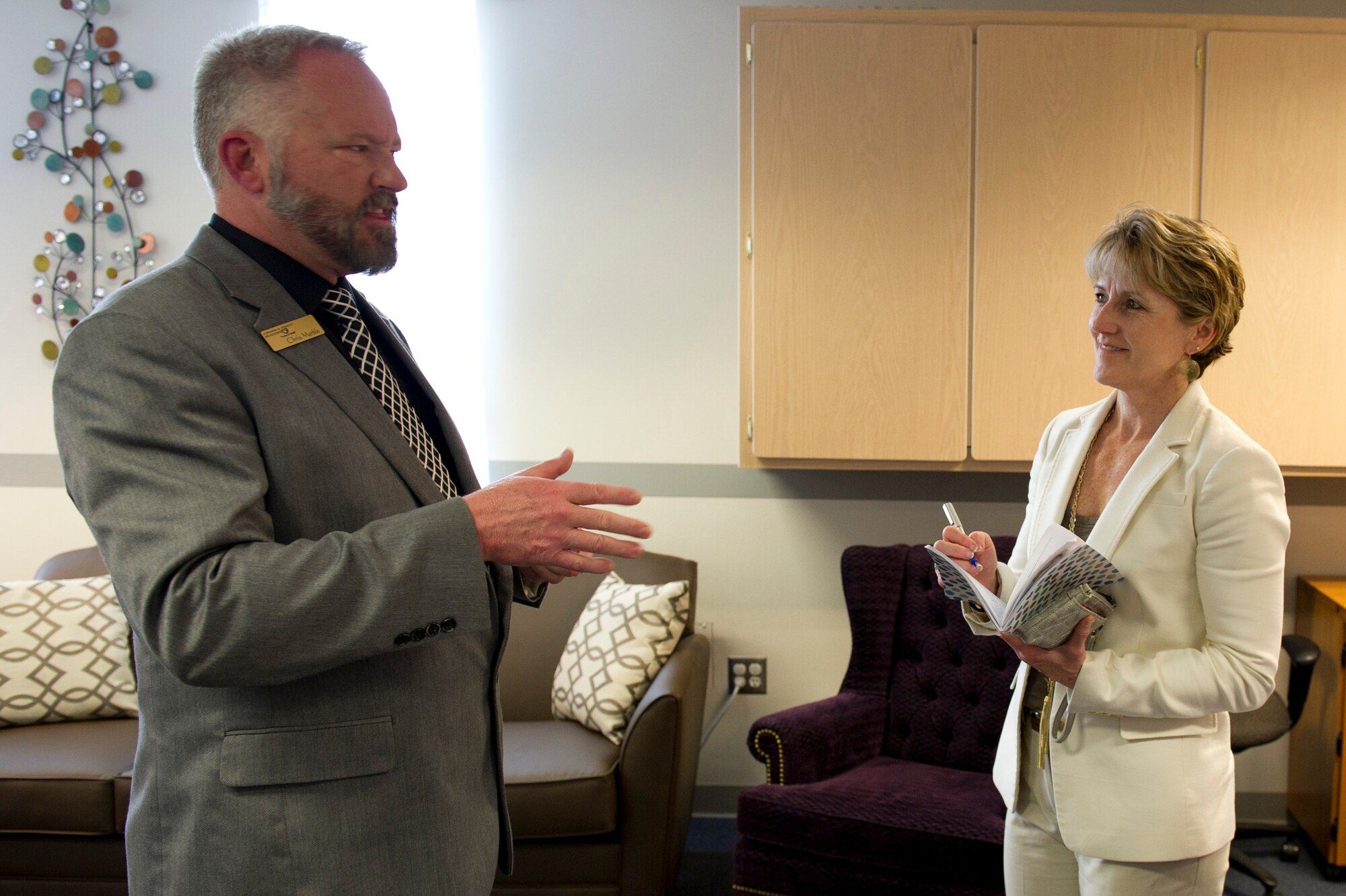 Chris Marble, 92nd Force Support Squadron Airman and Family Readiness Center chief, speaks with Tammy Cox, spouse of 18th Air Force commander Lt. Gen. Sam Cox, about the different programs the AFRC offers to military members and their families during a base tour May 4, 2016, at Fairchild Air Force Base, Wash. The AFRC provides services and resources such as career management, volunteer resources, personal financial readiness, military child education and family life counselor services. (U.S. Air Force photo/Airman 1st Class Nick J. Daniello)