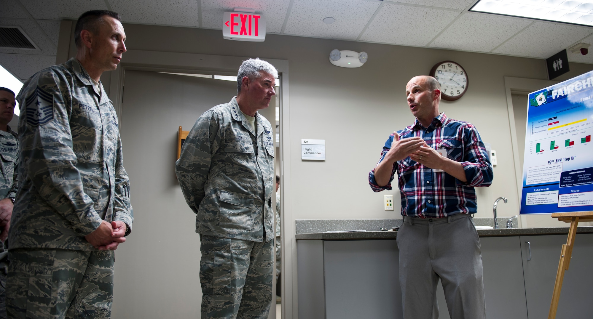Lt. Gen. Sam Cox, 18th Air Force commander, and Chief Master Sgt. Todd Petzel, 18th AF command chief, are briefed on some of the different health programs that the base offers by Mr. Will Saultes, 92nd Aerospace Medicine Squadron Health and Wellness Center, health promotion manager May 5, 2016, at Fairchild Air force Base, Wash. While at the 92nd Medical Group clinic, Cox and Petzel received a medical briefing on the new Electronic Health Records system being used at the clinic. (U.S. Air Force photo/ Airman 1st Class Sean Campbell)